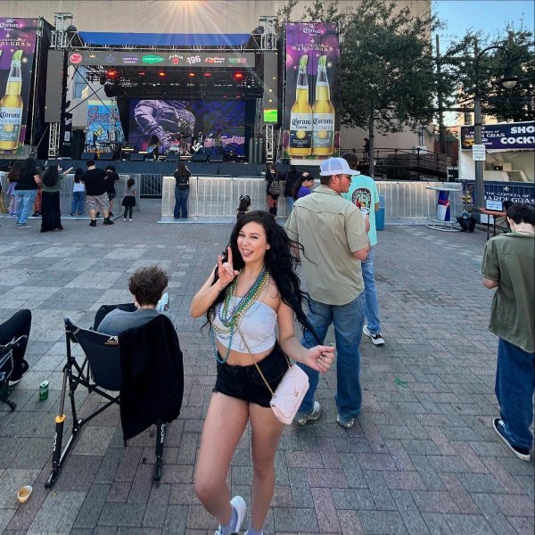 Simple Mardi Gras outfit featuring a tube top, short denim jeans, and colorful bead necklaces.