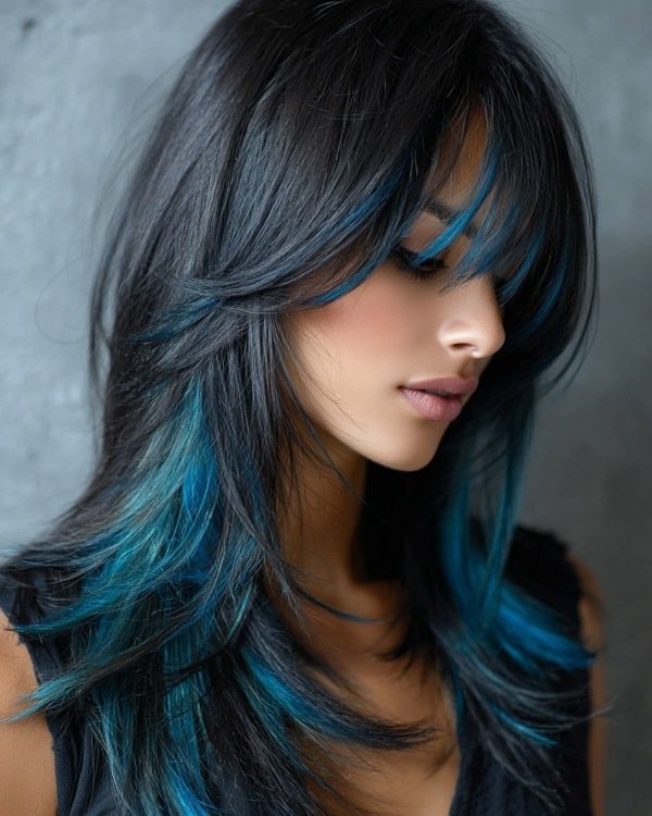 Jet black hair with vibrant blue peekaboo highlights underneath, styled sleek and straight.