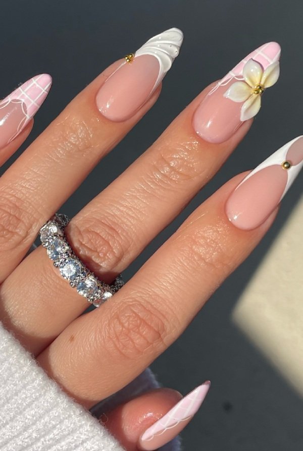 Glossy white nails with subtle tropical leaf details, clean and minimal beach aesthetic.