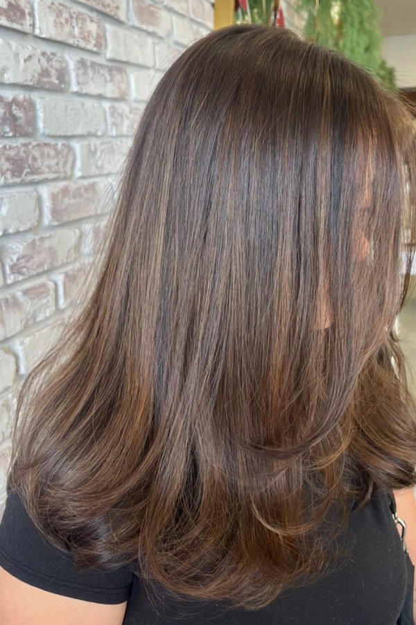 Warm toffee brown hair with soft highlights hiding grey hair