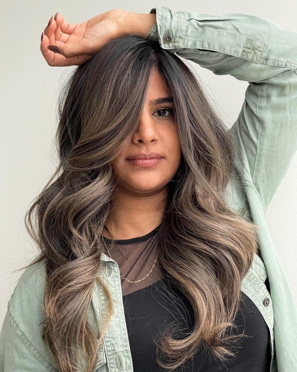 Sandy brown hair color with soft highlights blending grey strands