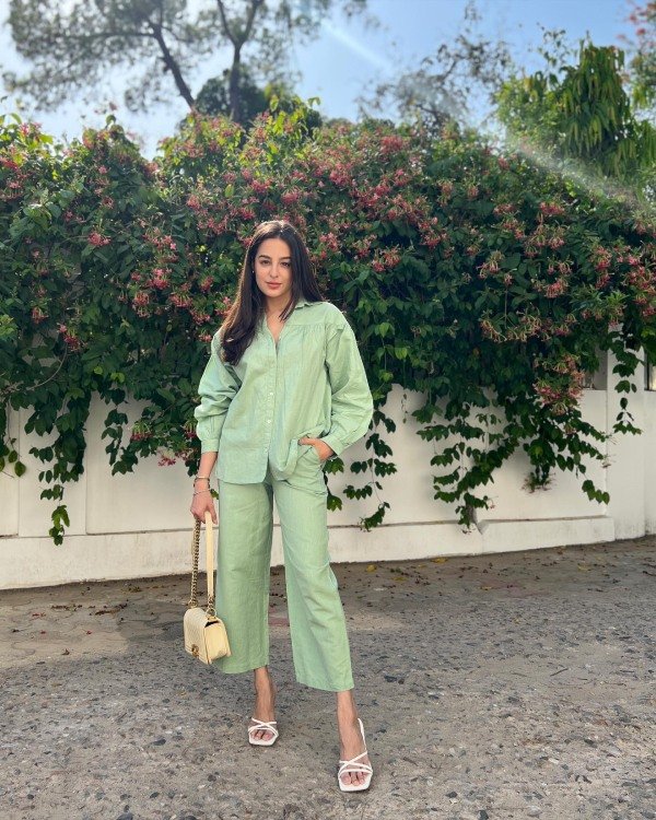Sage linen matching set with button-down shirt and shorts styled for a summer party