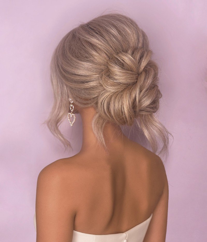 Low Bun with Face-Framing Tendrils graduation hairstyles