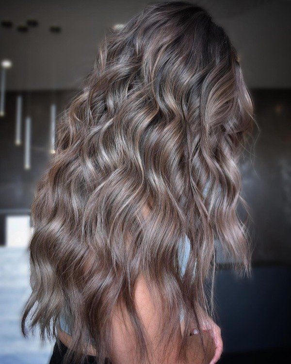 Woman with mushroom brown hair color featuring cool grey-brown tones and natural blended dimension