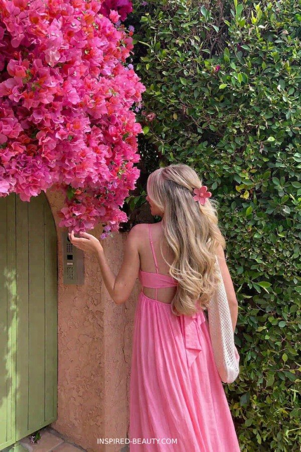 Woman in a flowy maxi dress with open bavk styled for an outdoor summer evening party