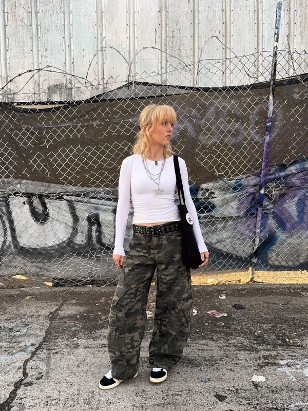Street-style school outfit featuring cargo pants, crop top, and chunky sneakers.