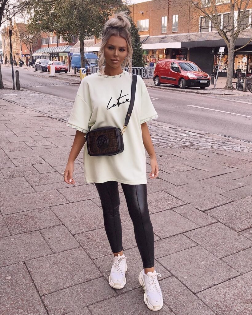 Leather leggings styled with a graphic t-shirt and denim jacket for a casual weekend outfit.