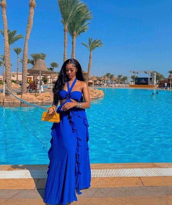 Woman wearing a bright blue dress for a stylish Hawaii vacation dinner outfit.